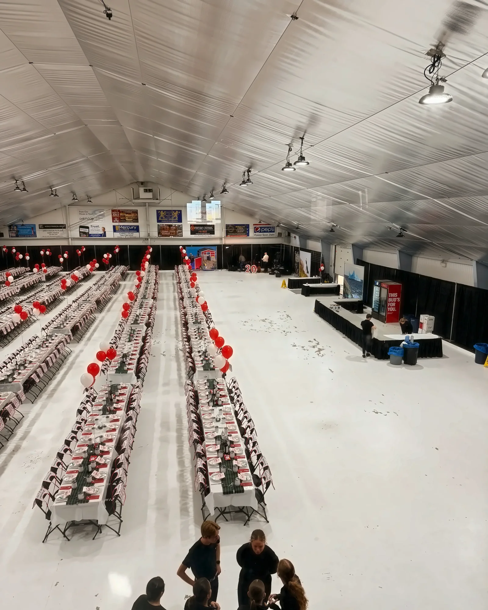 Fireside Catering staff in a large hall set for a catered dinner event in Newfoundland