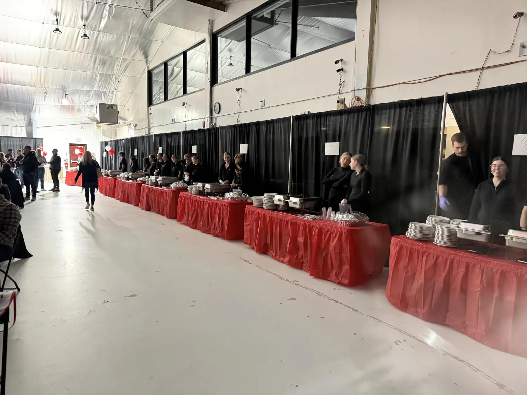 Fireside Catering staff serving a long buffet line at a large catered event in Newfoundland